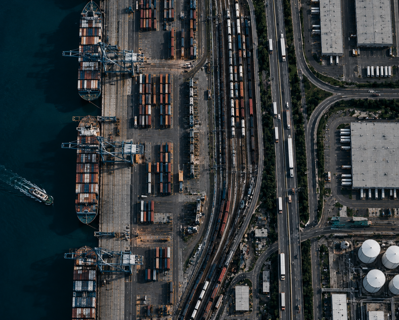 Aerial view of a container port, rail yard, and trucks