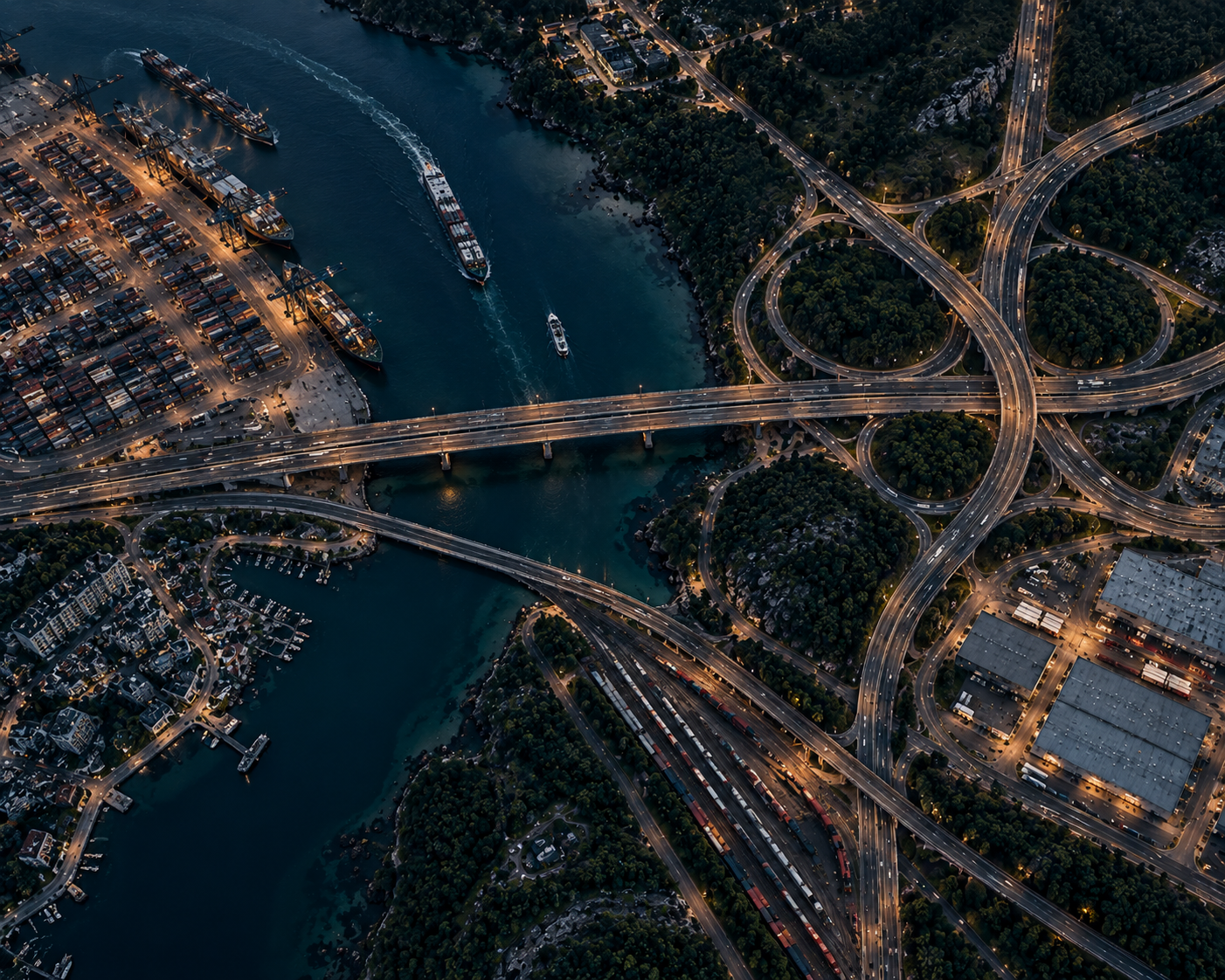 Night aerial of a port, bridges, and highway interchange